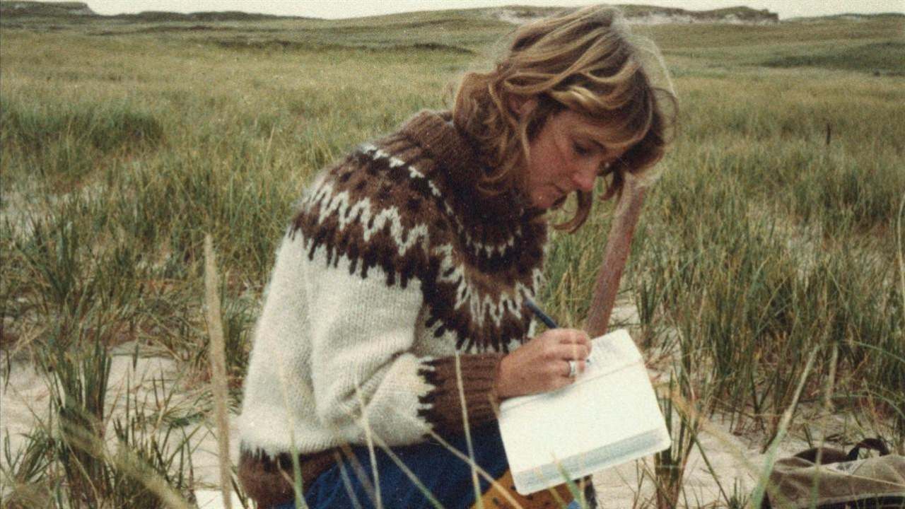 a woman writing in a book